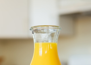 yellow liquid in clear glass bottle