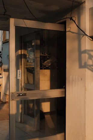 An industrial sectional door partially open, revealing a bright warehouse interior.