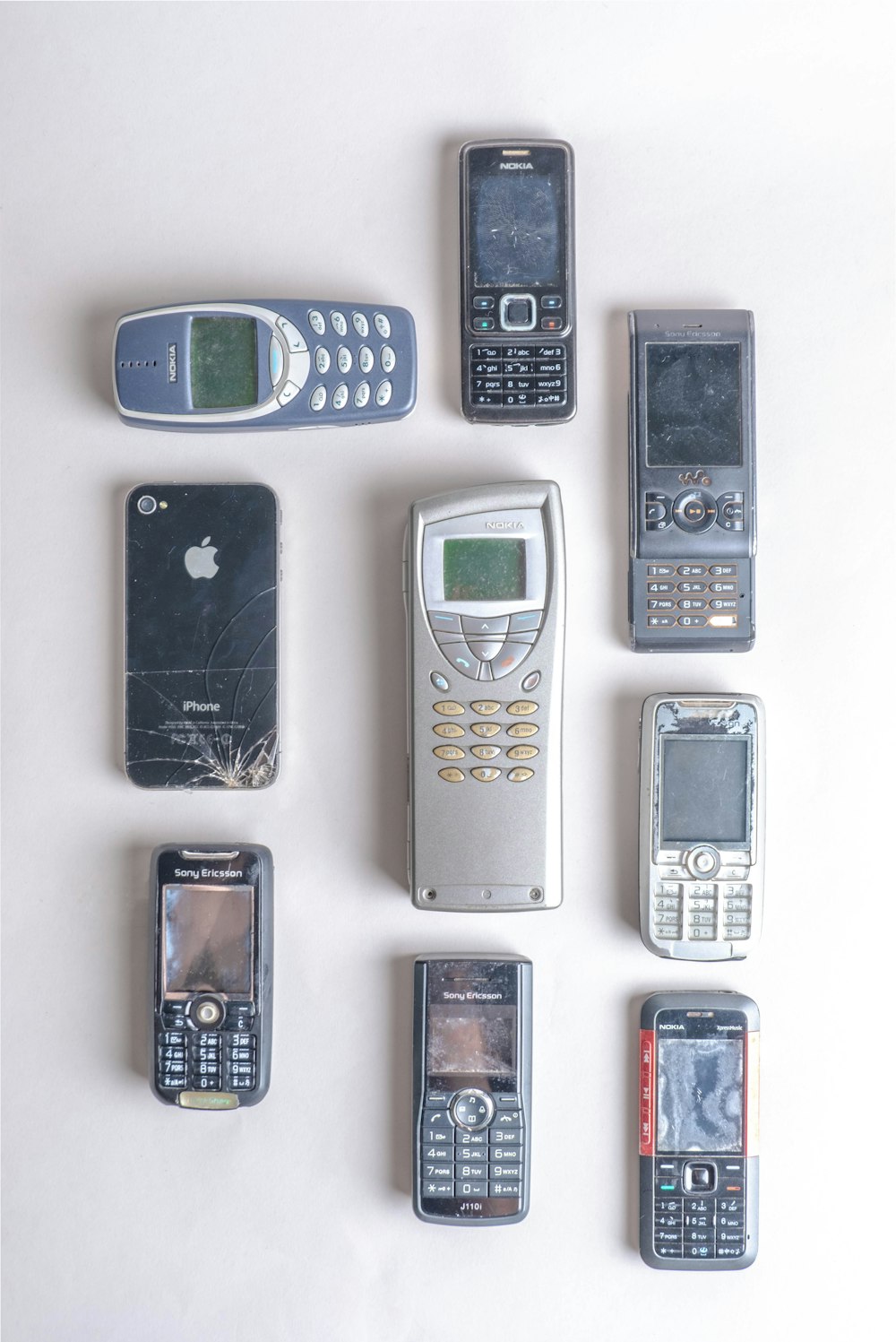 assorted color candybar phones on white surface