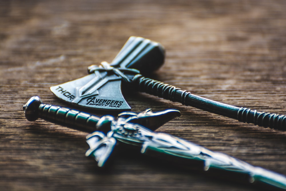 silver skeleton key on brown wooden table