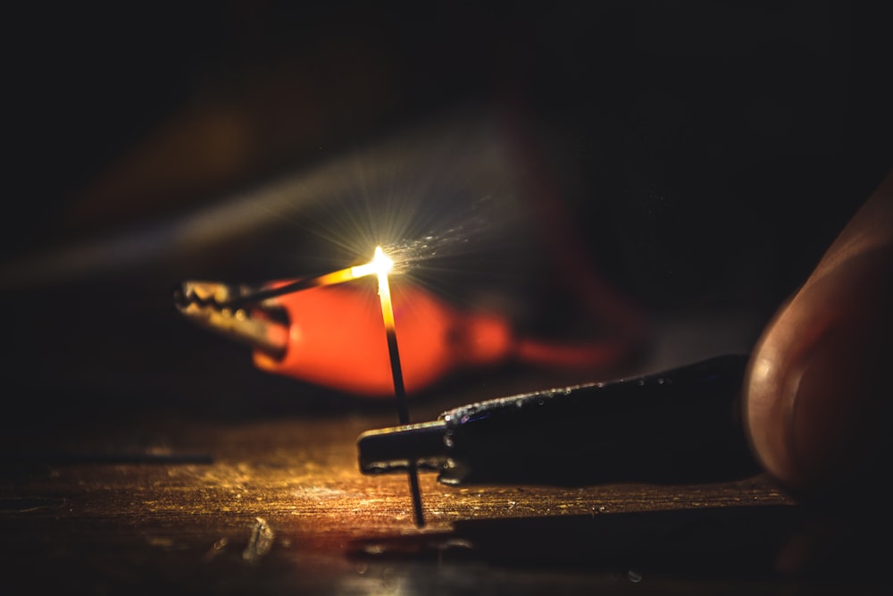 lighted cigarette stick on brown wooden table