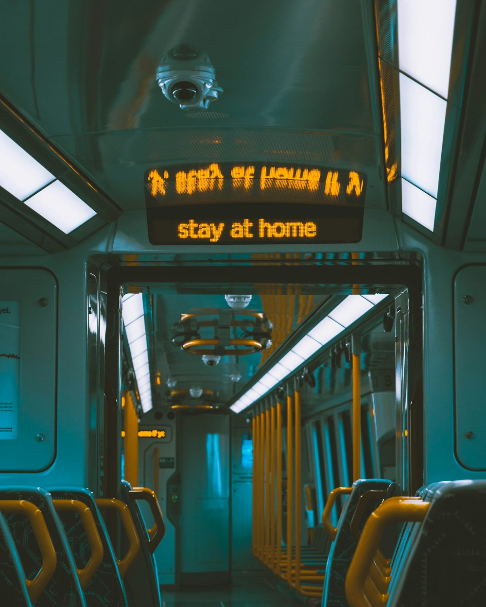un vagone della metropolitana con un cartello che dice di stare a casa