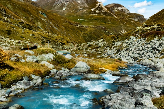 green and brown mountains beside river during daytime in Moiry Switzerland