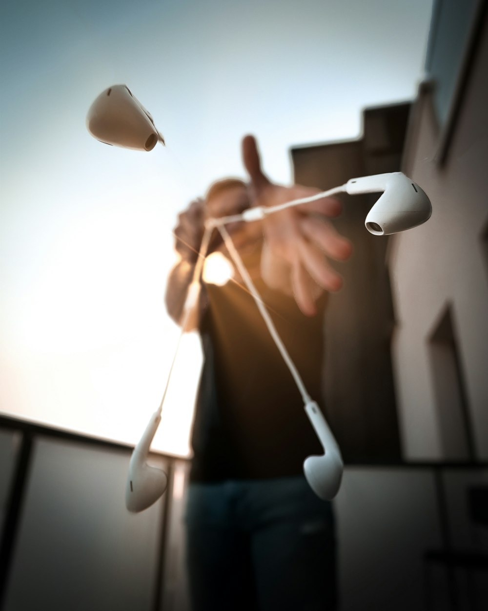 woman in blue denim shorts holding white and silver balloons