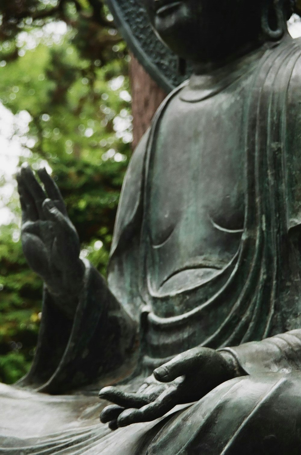 black statue of man holding book