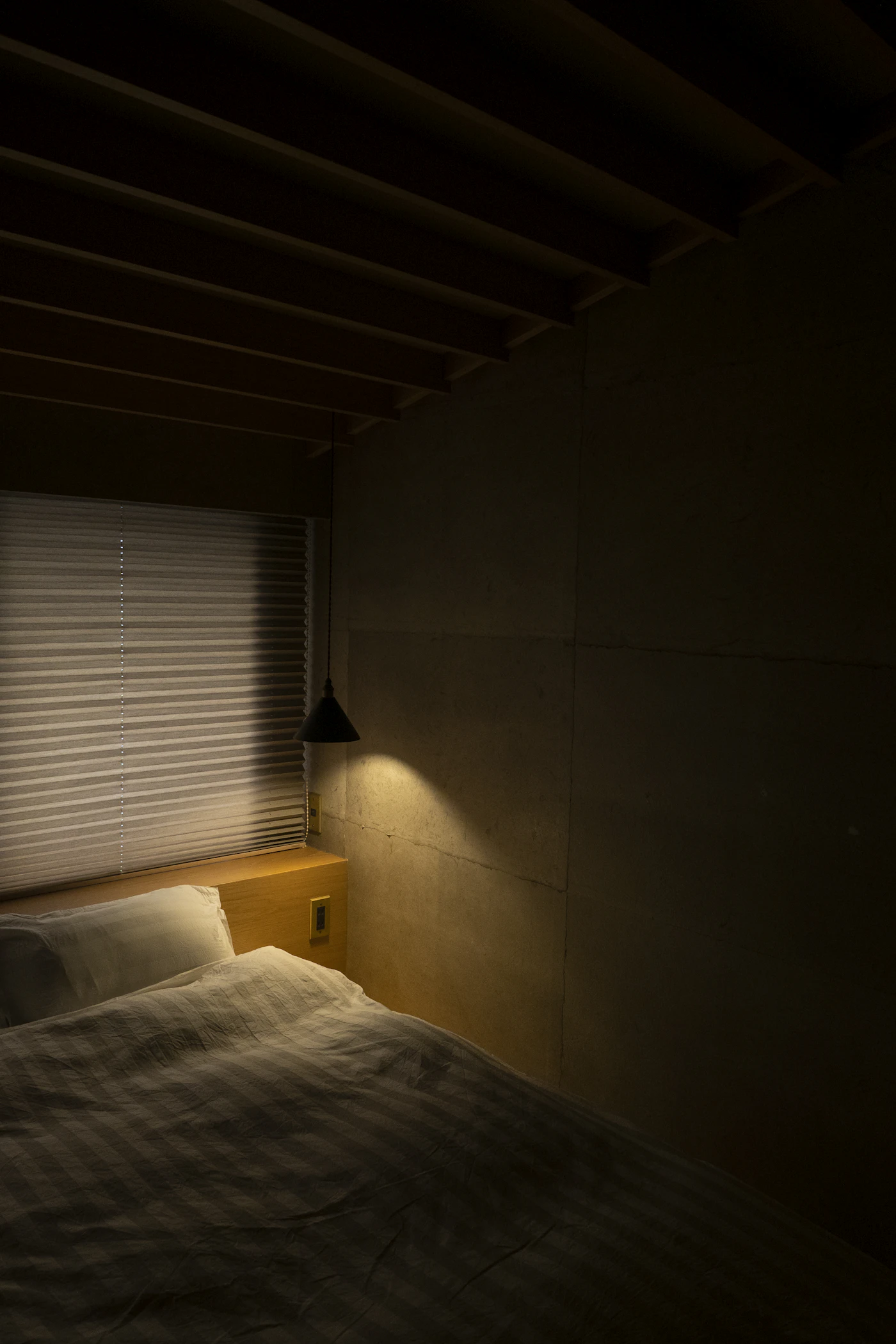 Bedroom in warm timber with soft evening light