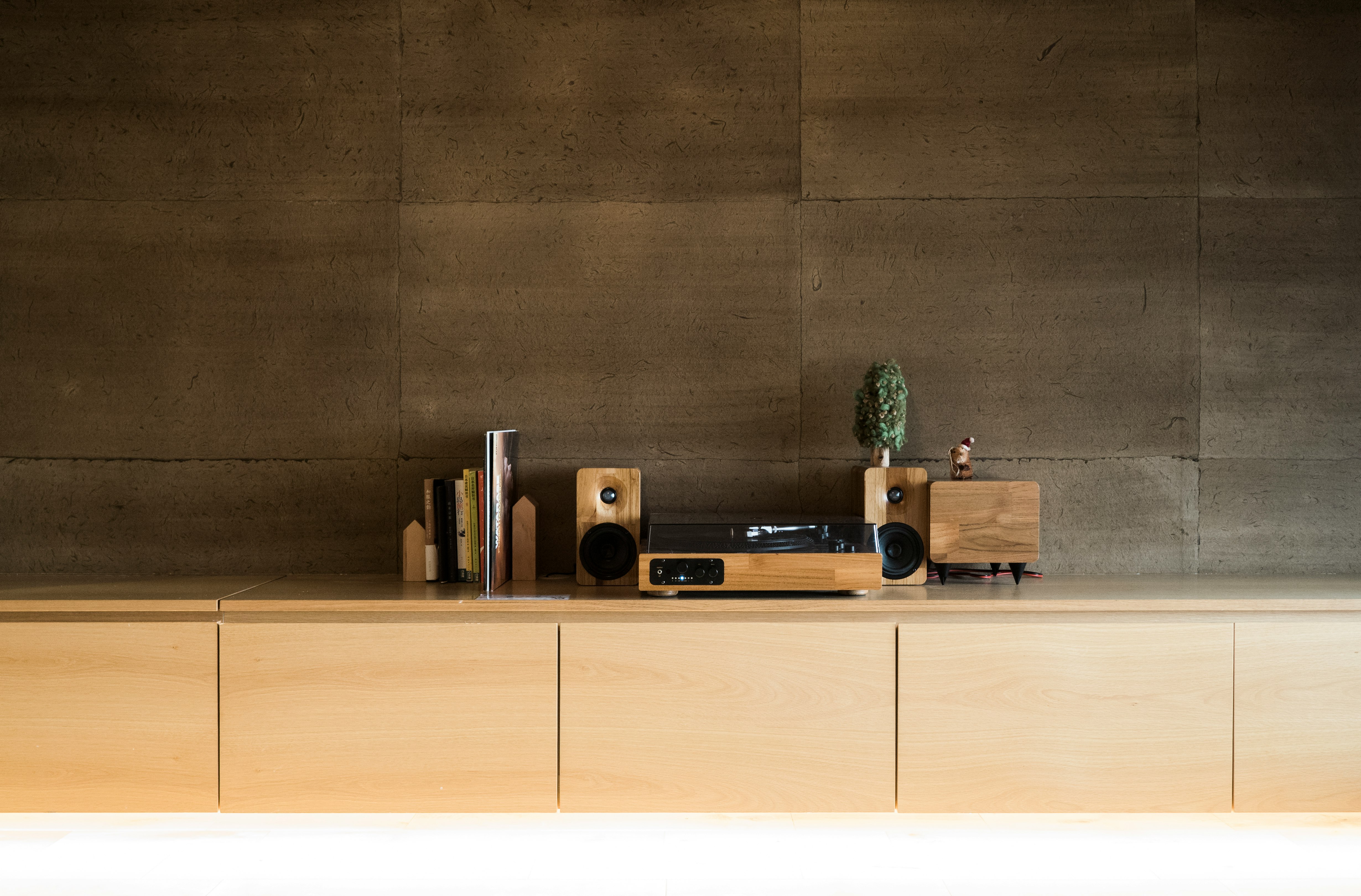 brown and black speaker on brown wooden shelf