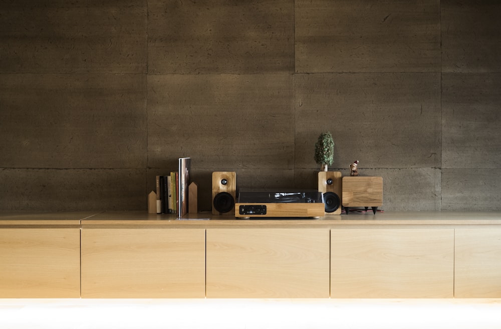 brown and black speaker on brown wooden shelf