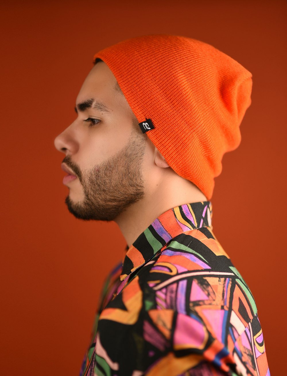 man in orange knit cap