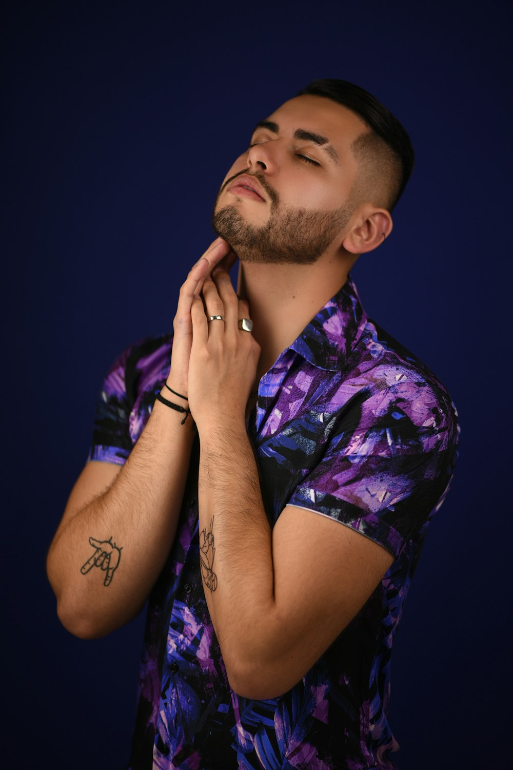 man in purple and white floral button up t-shirt