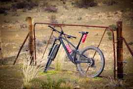 black and red mountain bike on brown grass field during daytime