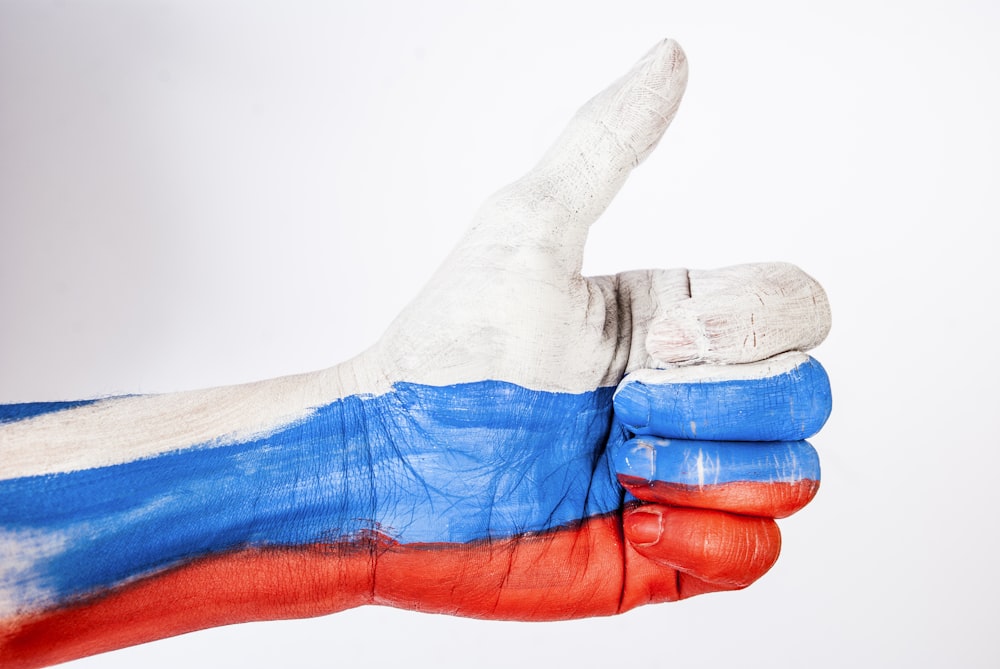 persons hand with blue paint