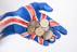 person in blue red and white long sleeve shirt wearing silver round coins