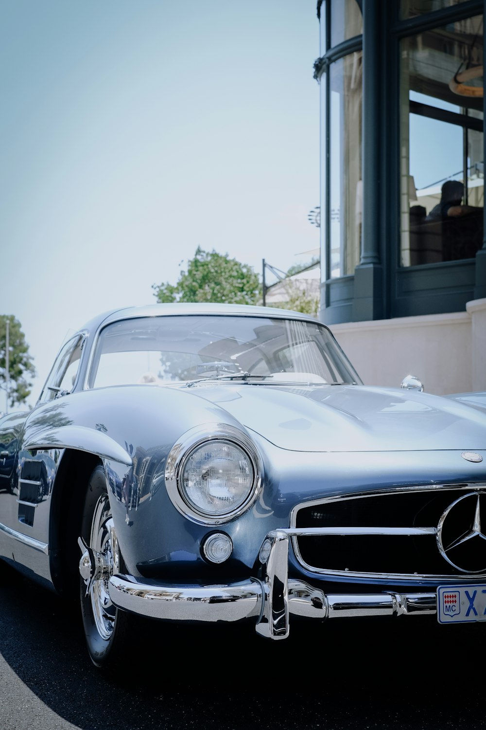 white mercedes benz coupe parked near building during daytime