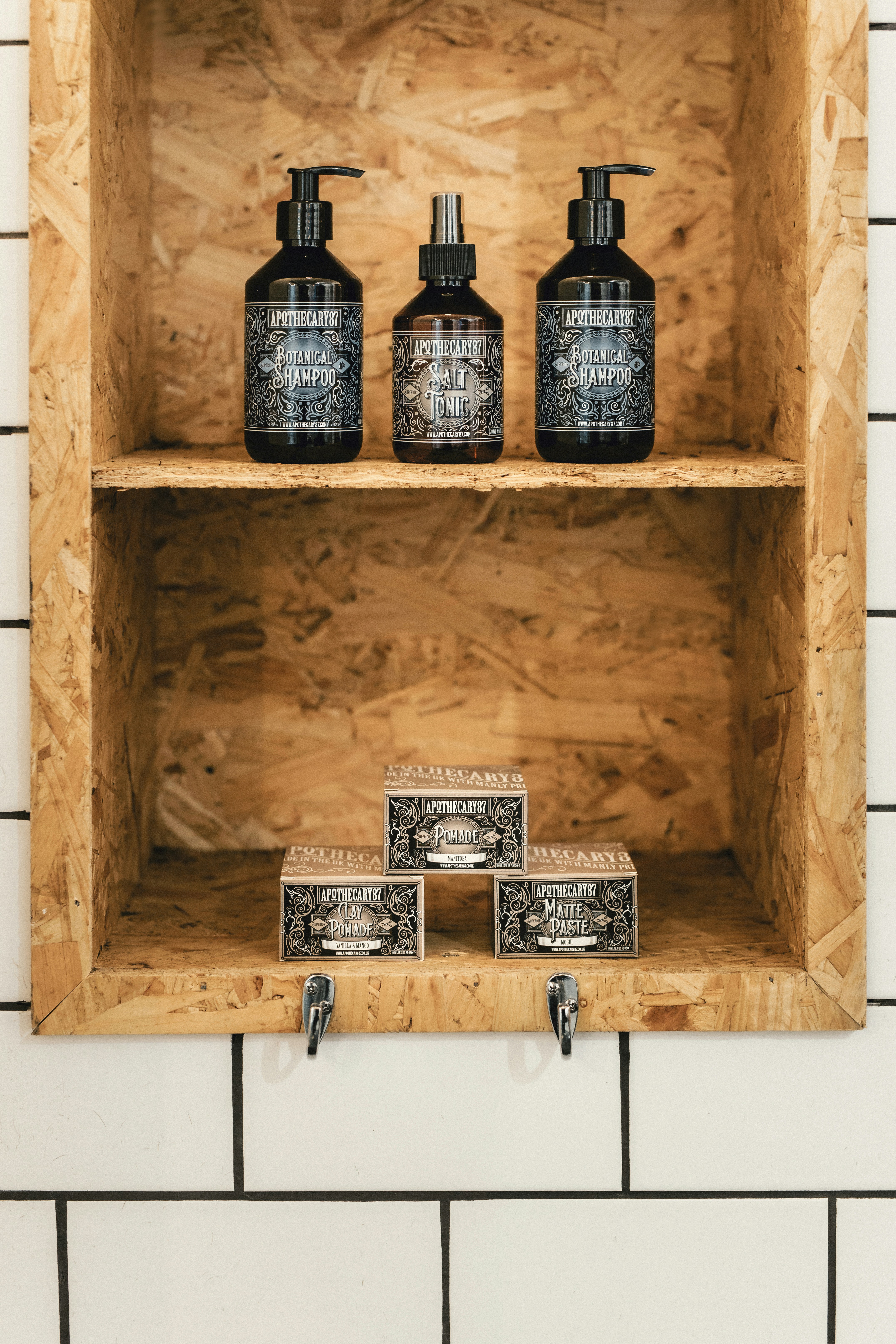 black bottles in brown wooden shelf