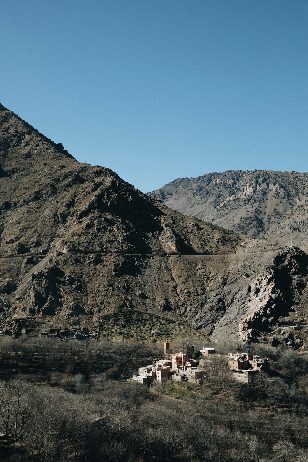 people walking on road near mountain during daytime