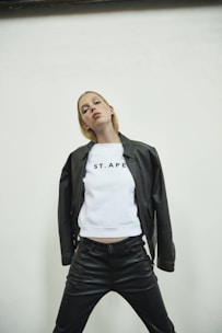 A sleek black leather jacket styled with a crisp white tee and tailored trousers, embodying effortless cool.