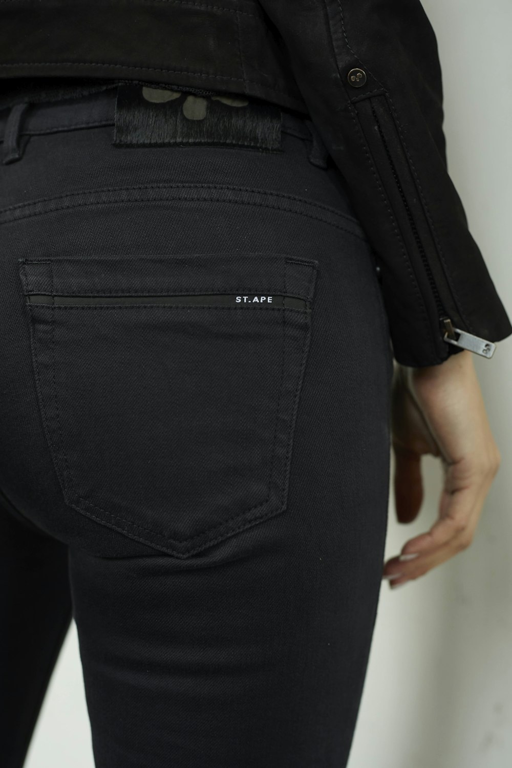 a close up of a person wearing black jeans