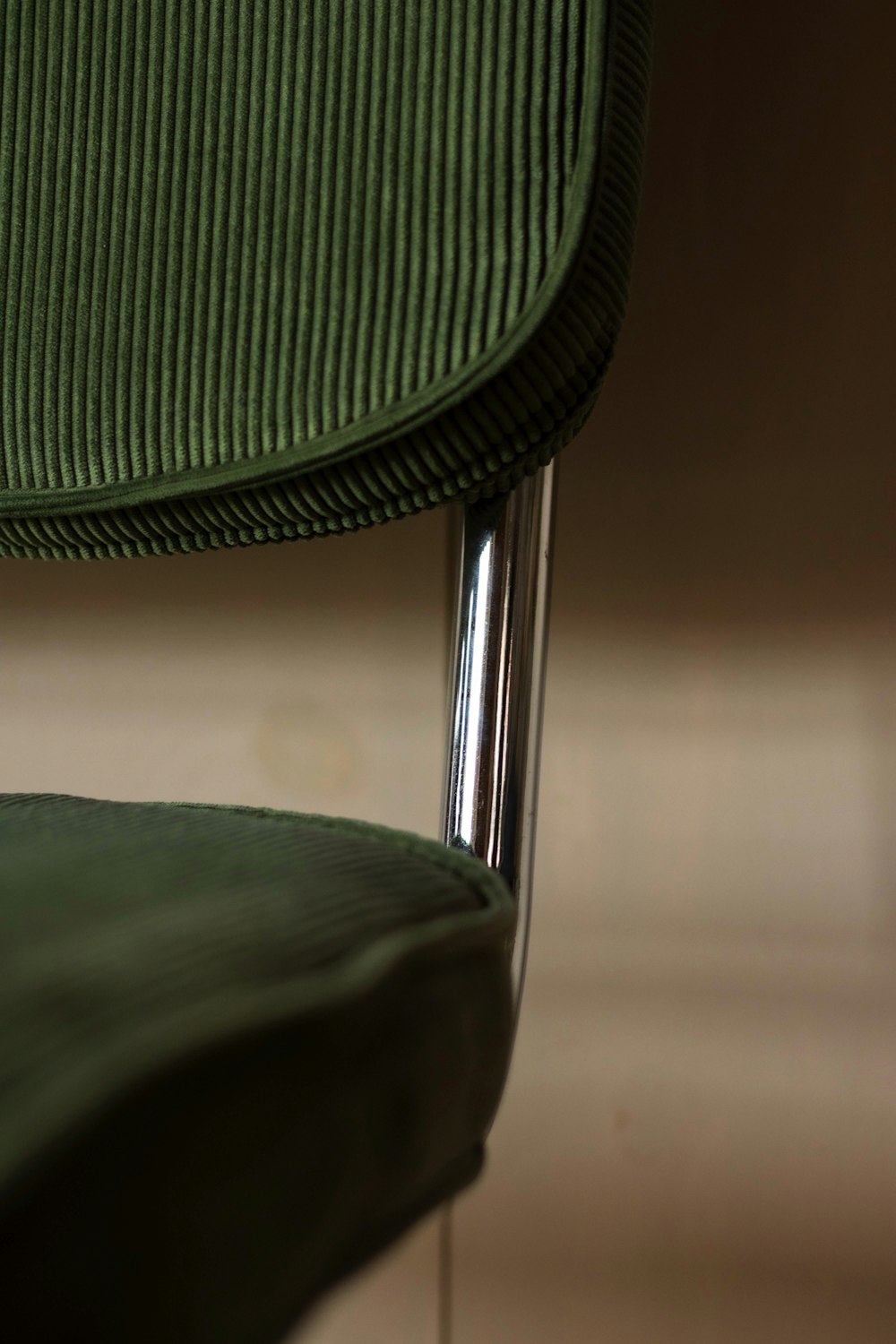 green and black chair on brown floor