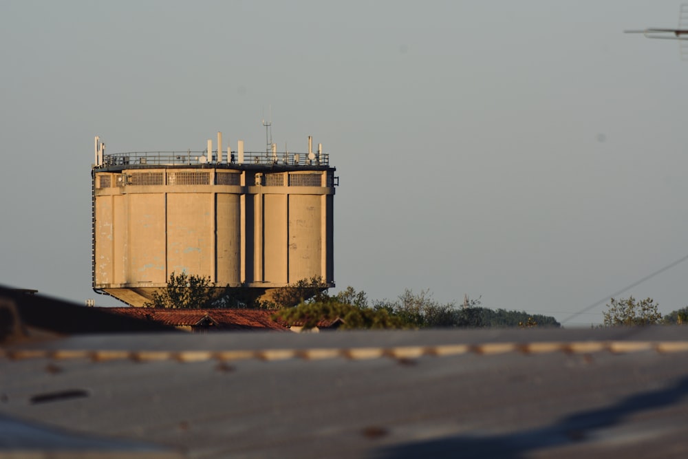 brown steel tank on gray asphalt road during daytime