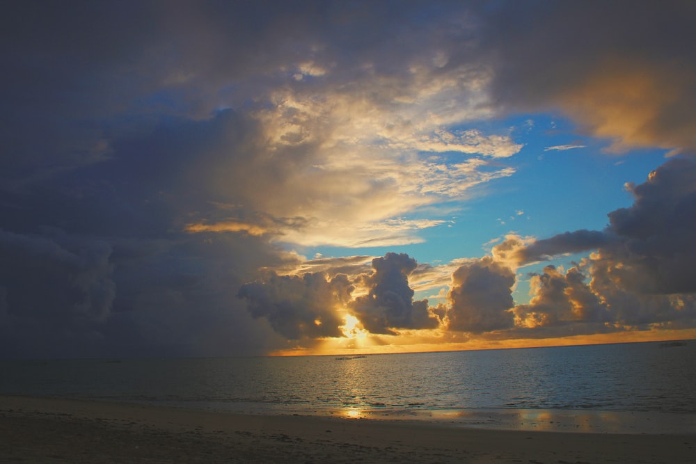 sea under blue and white cloudy sky during daytime