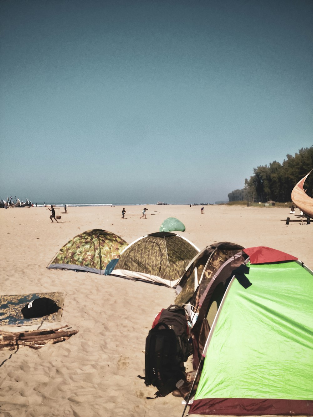 green tent on beach during daytime