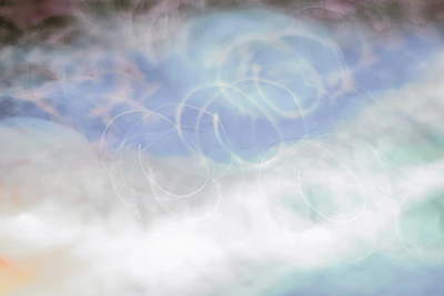 Soft pastel background with swirling galaxy and light energy patterns.