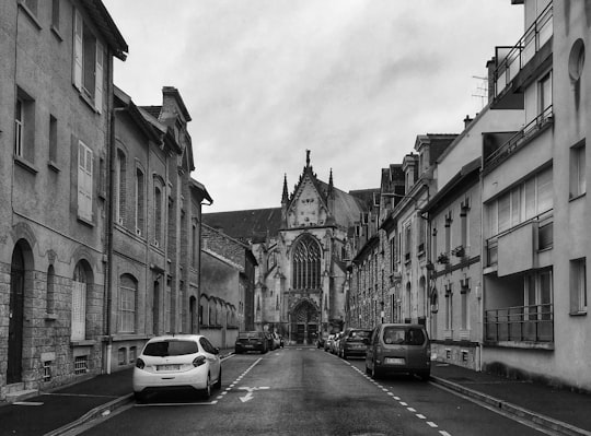 grayscale photo of cars parked beside building in Reims France