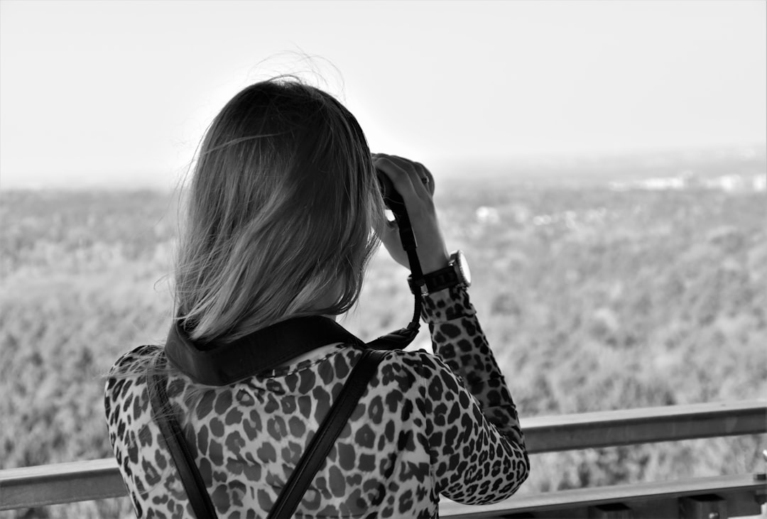 grayscale photo of woman in black and white leopard print jacket