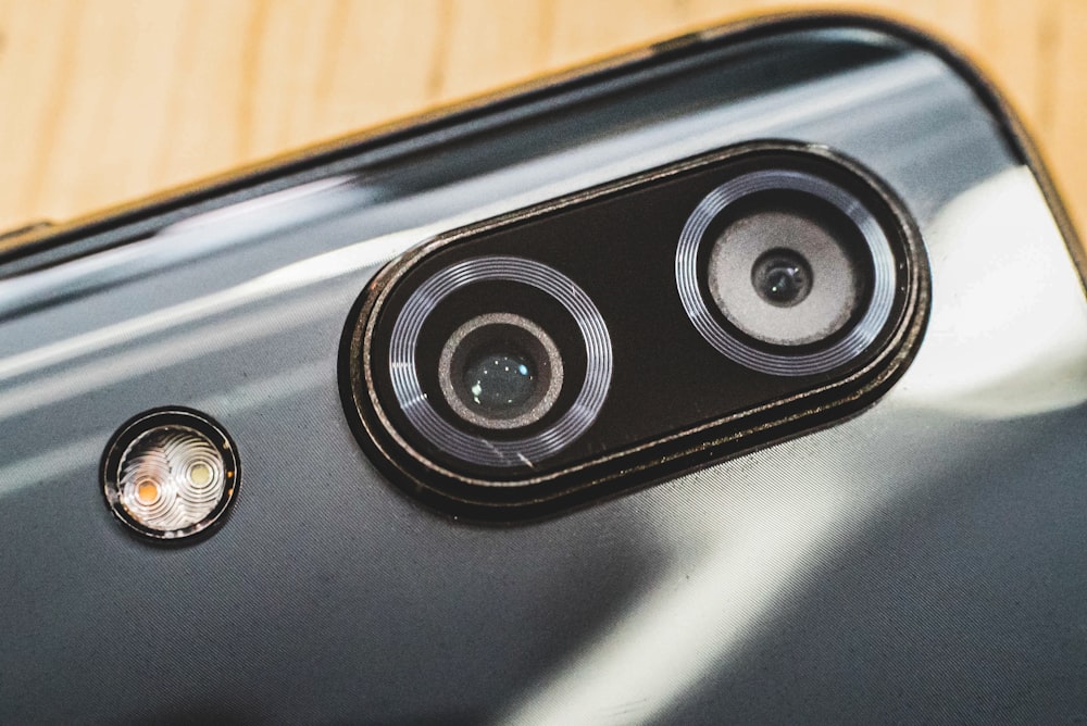 black and silver speaker on brown wooden table