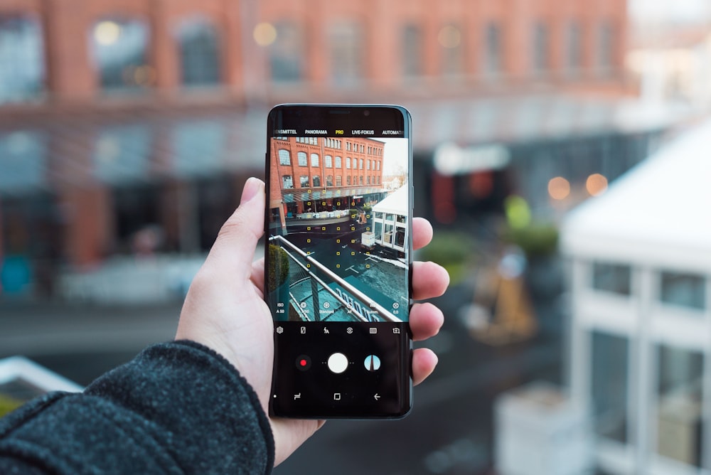 person holding black android smartphone