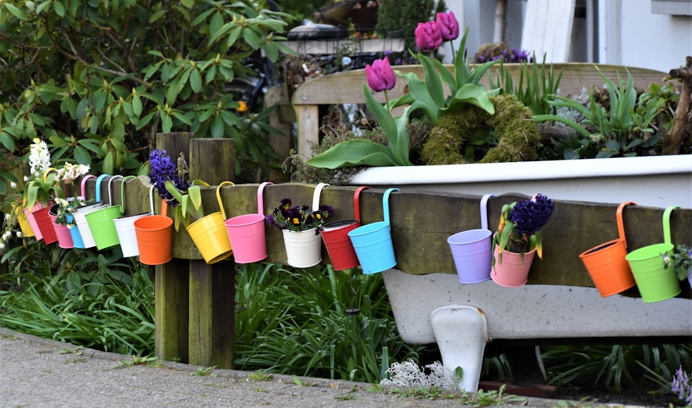 white plastic bucket with assorted color plastic cups