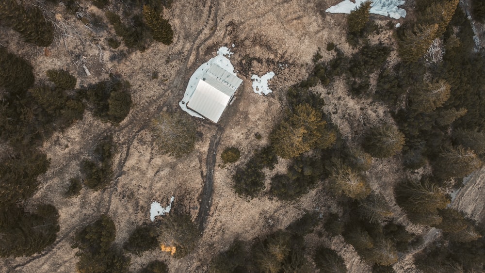 white and gray house on brown and black sand