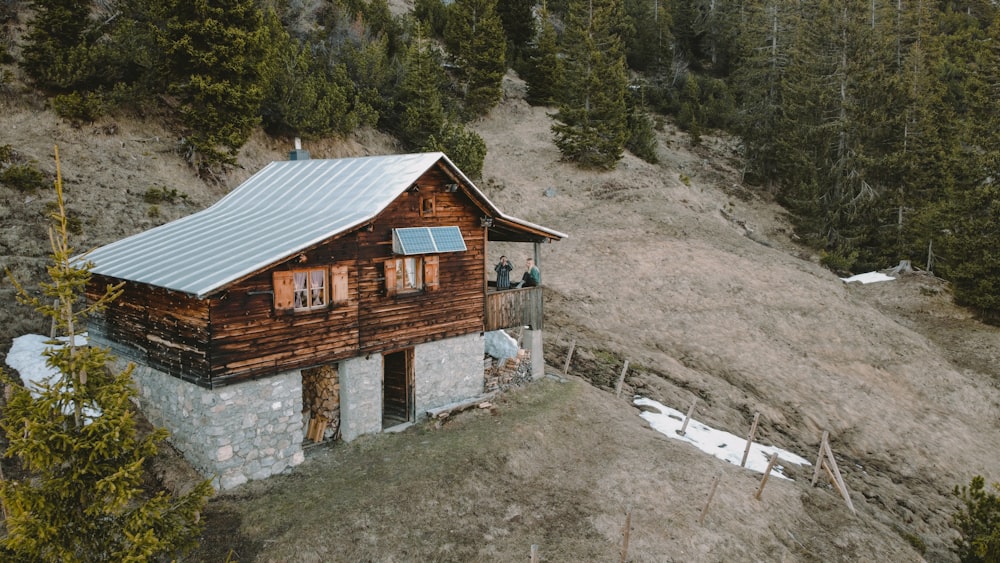 brown wooden house on rocky hill