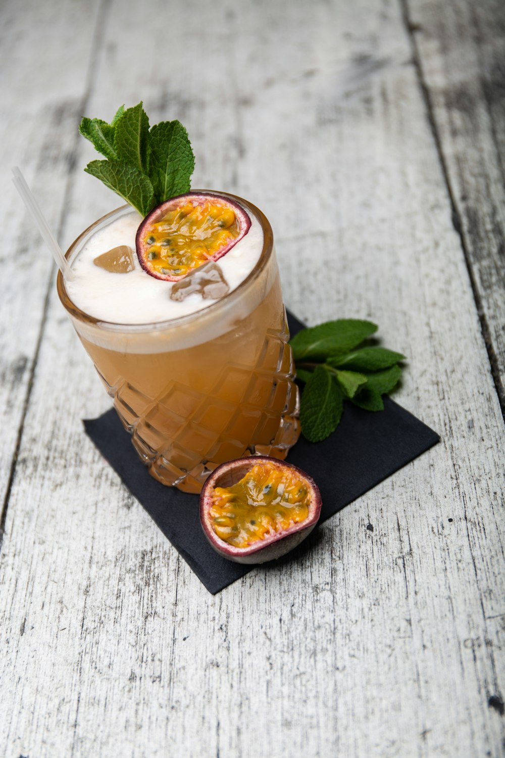 clear drinking glass with brown liquid and sliced orange fruit