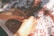 Close-up of hands sorting various wholesale products on a wooden table.