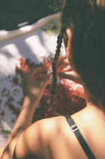 Close-up of hands sorting natural Indian raw hair strands in a bright, clean workspace.