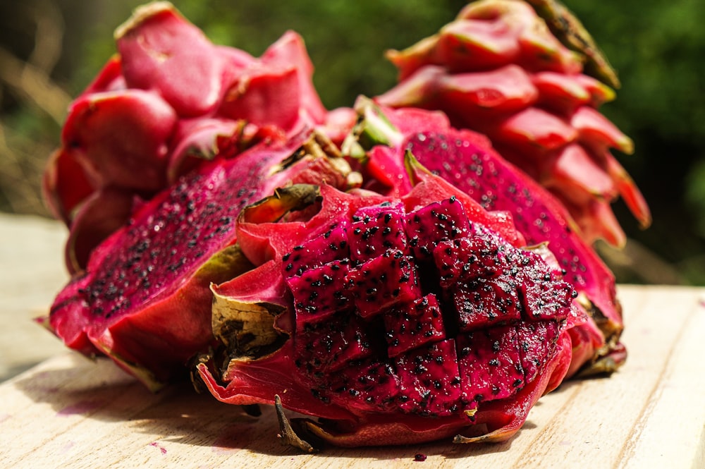 red sliced fruit on brown wooden table