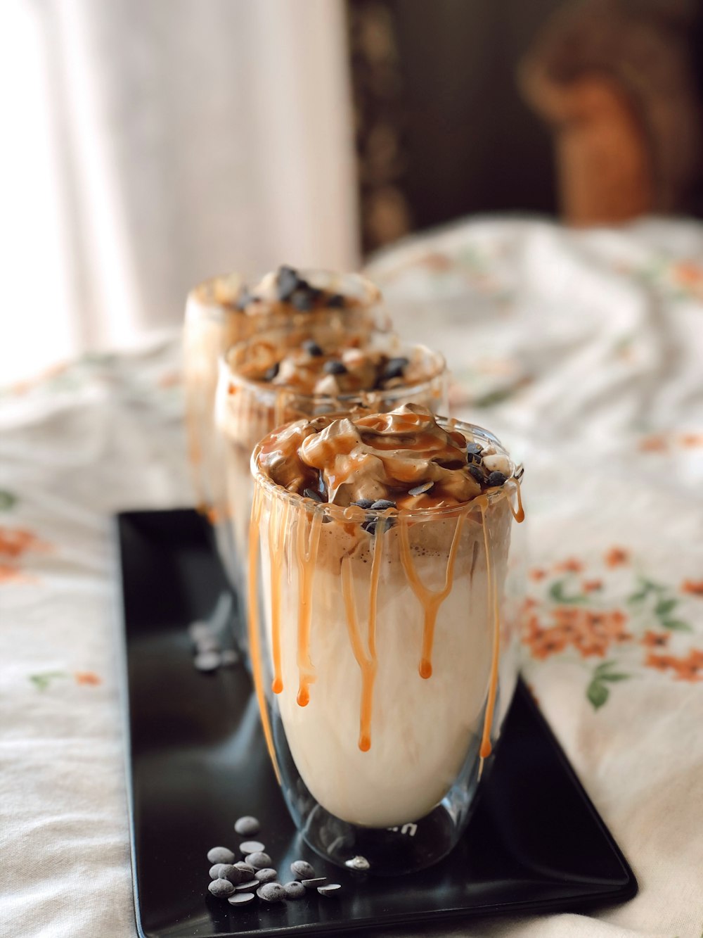 brown and white ice cream in clear glass cup