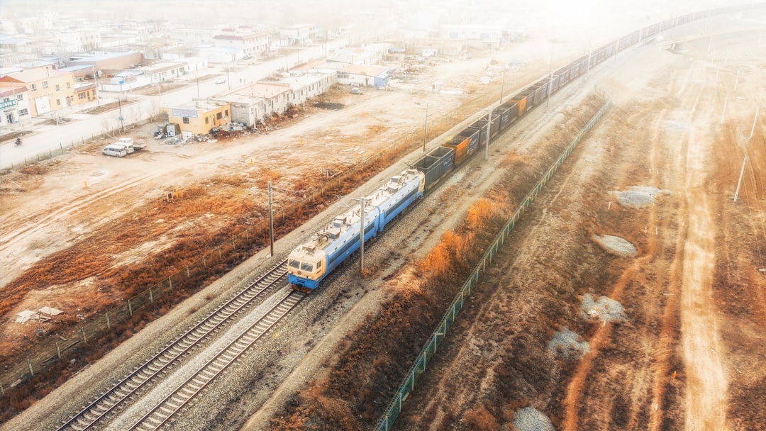 white and blue train on rail road during daytime