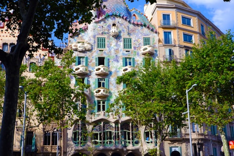 green trees in front of brown concrete building during daytime