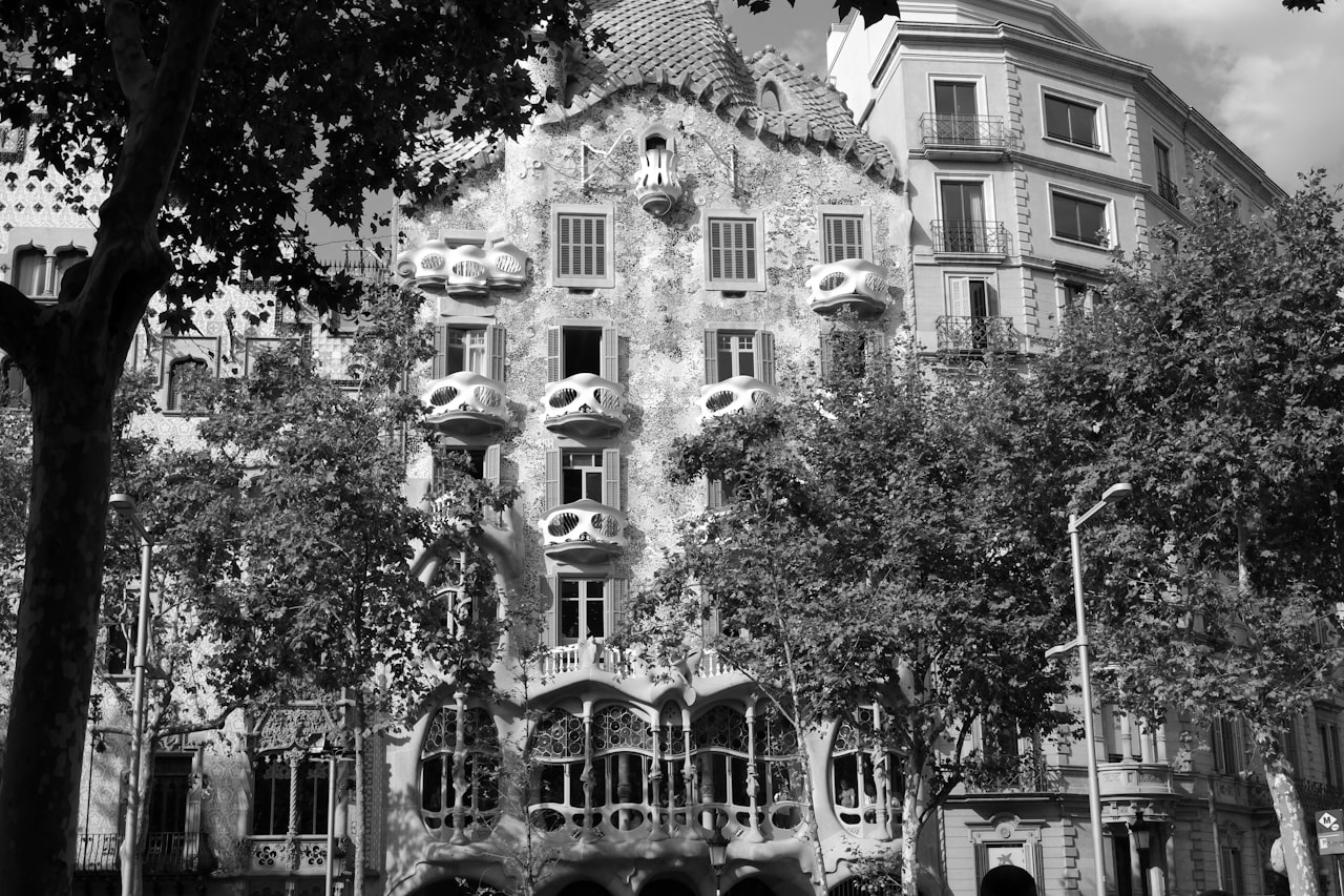Casa Batllo green trees in front of brown concrete building during daytime