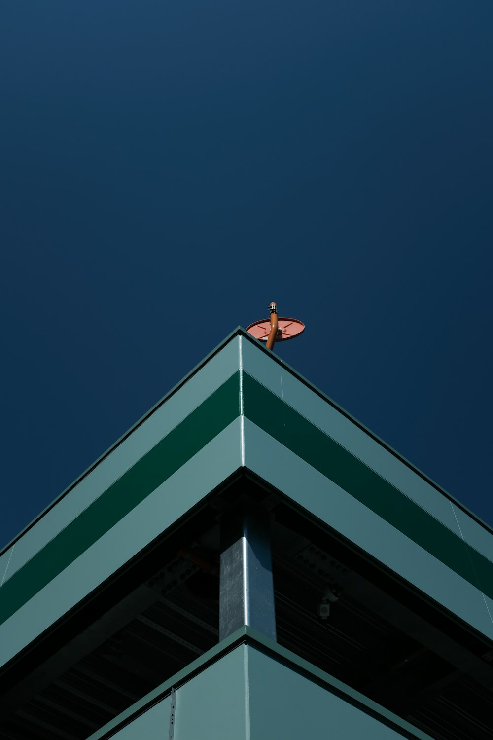 white and green concrete building under blue sky during daytime