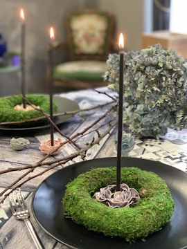 Elegant centerpiece with wax flowers arranged on a dining table.