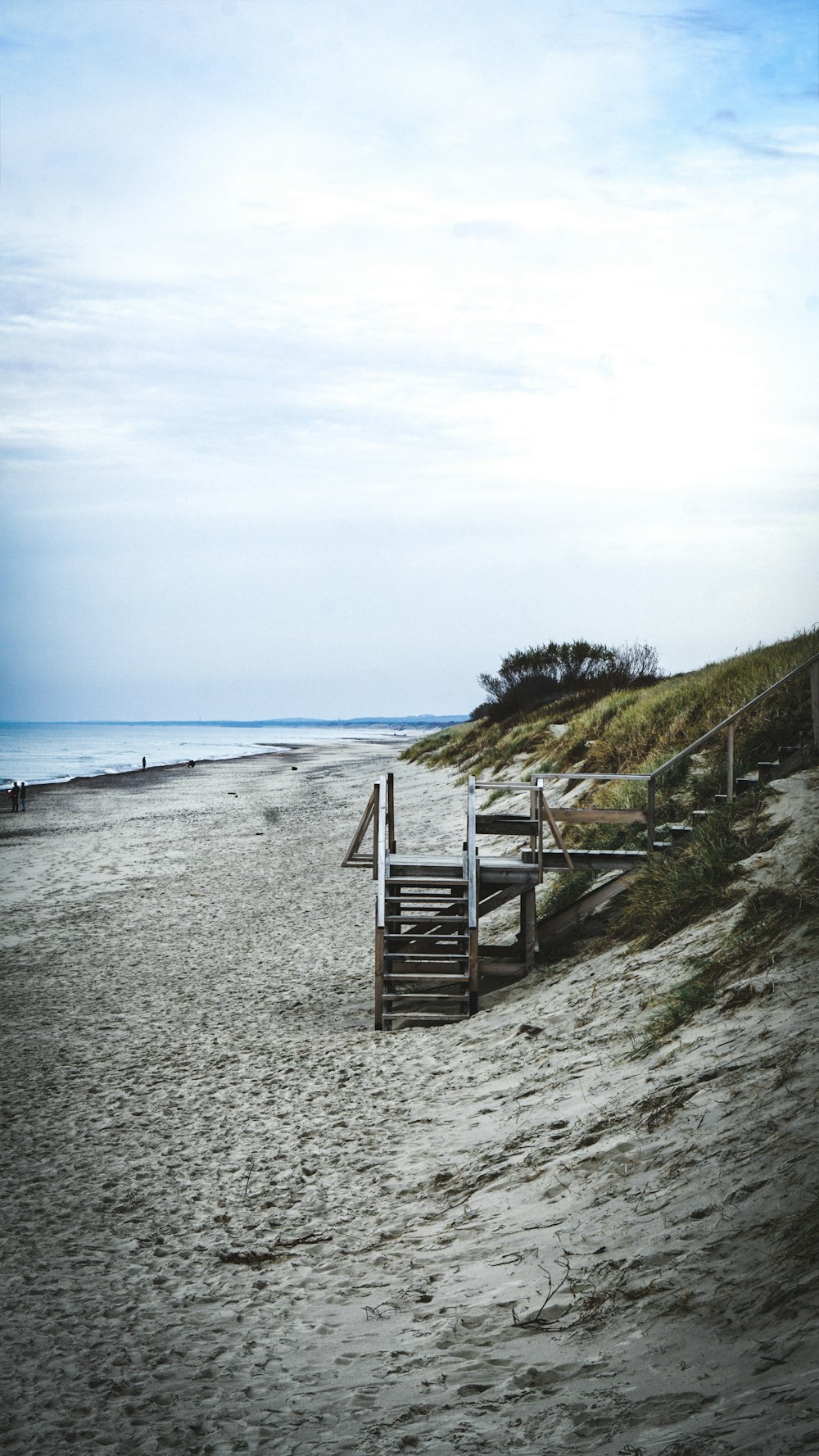 brown wooden fence on seashore during daytime