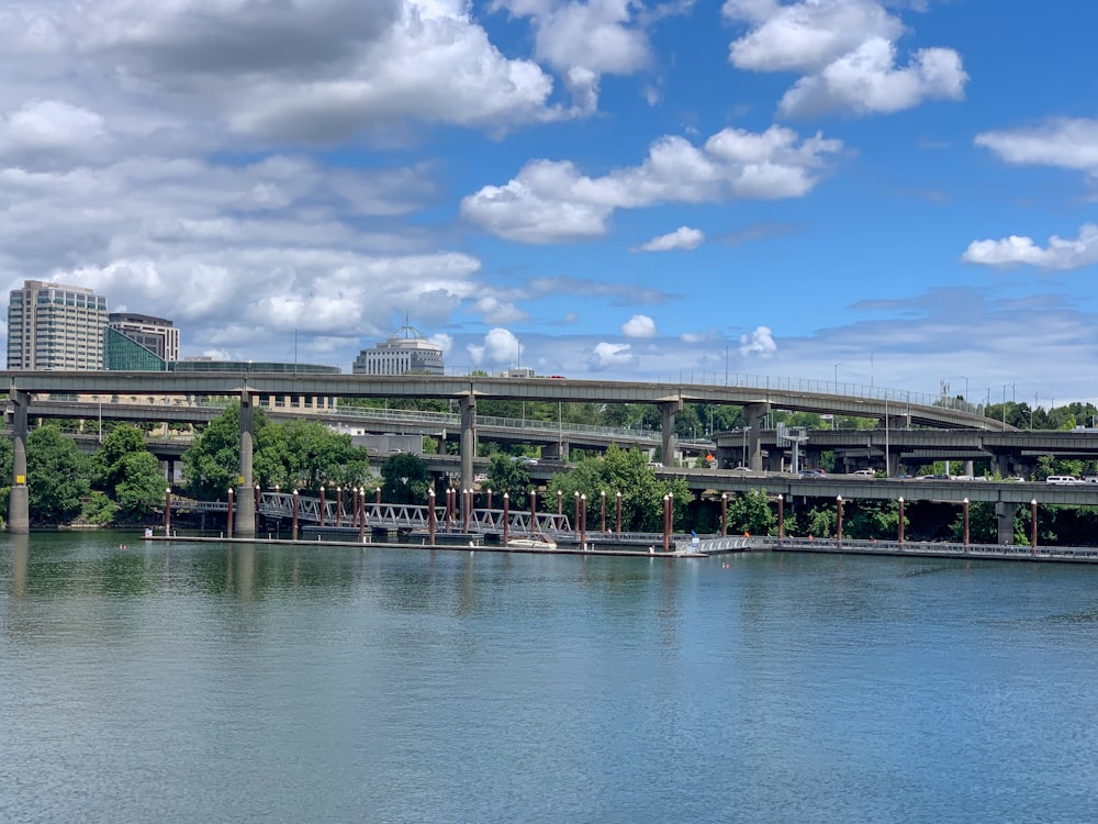 white bridge over the river under blue sky and white clouds during daytime