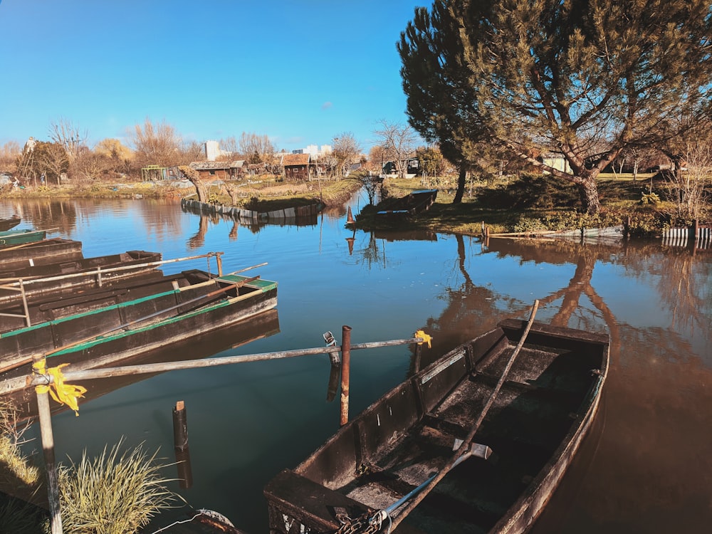 brown wooden boat on lake during daytime