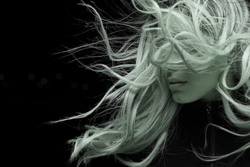 woman with white hair in black shirt