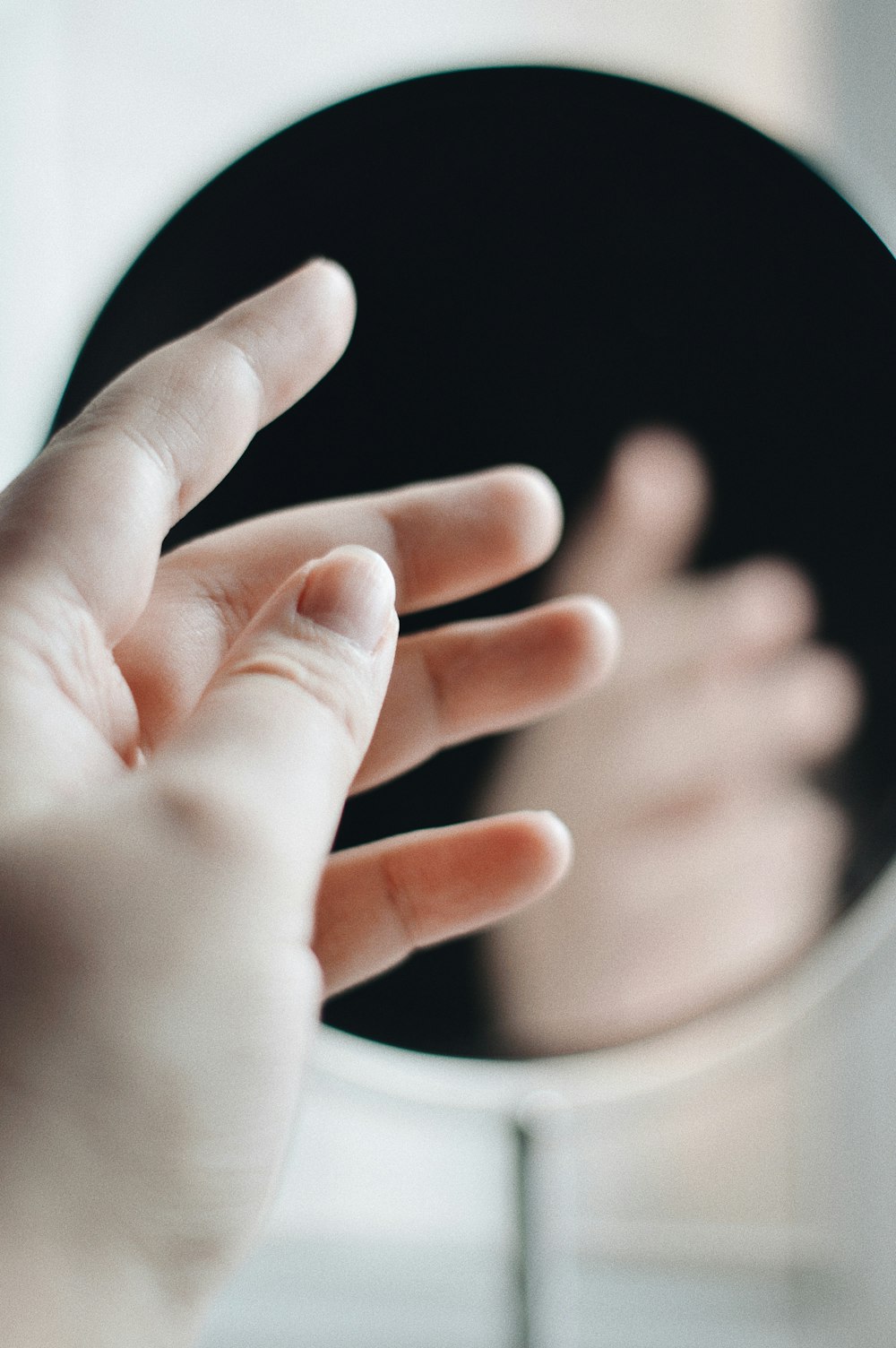 persons hand on white textile