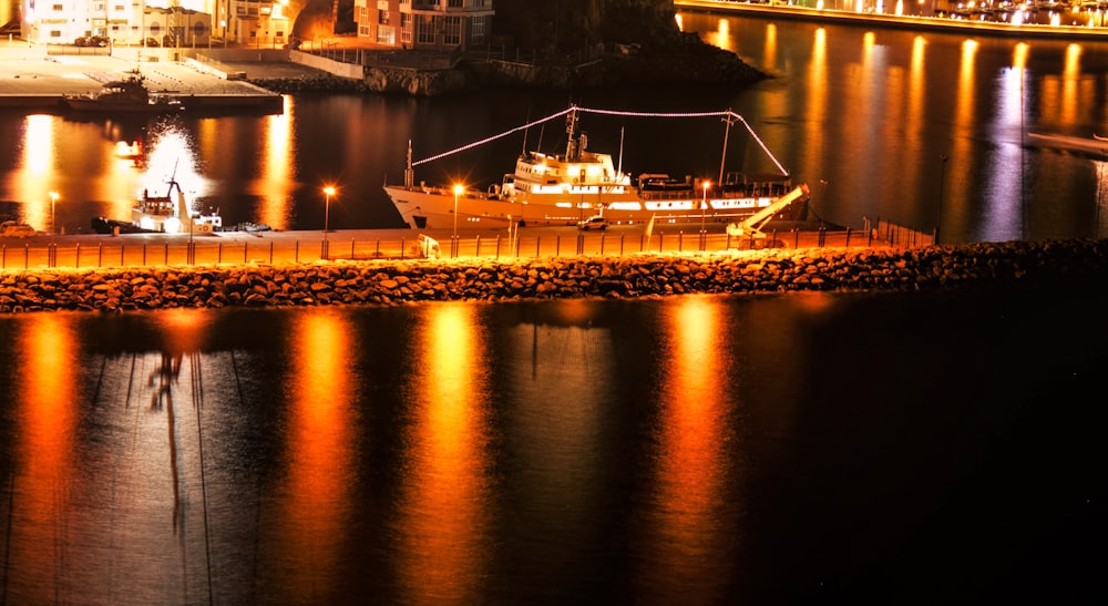 white ship on dock during night time